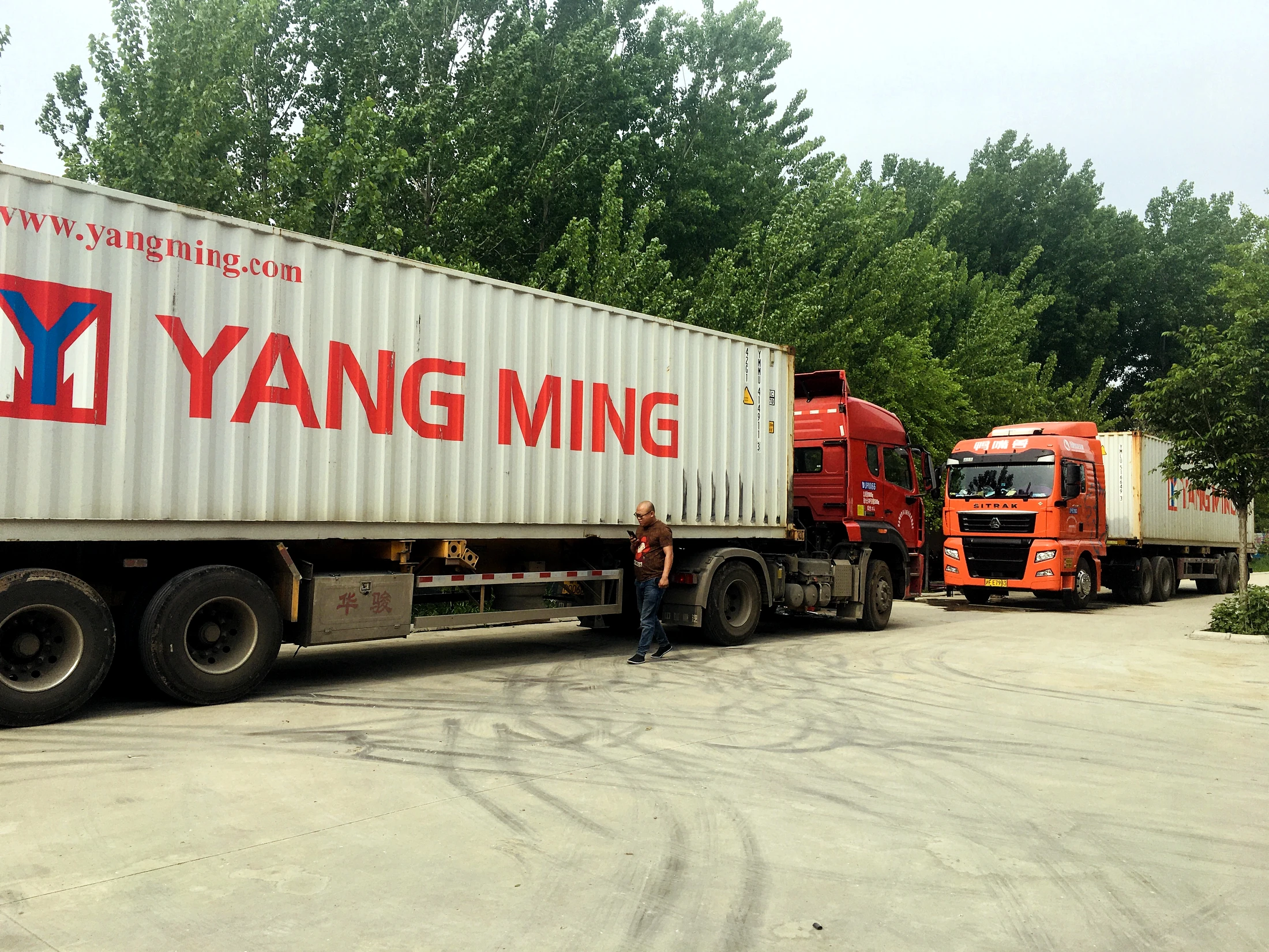 Container trucks prepared for outbound delivery